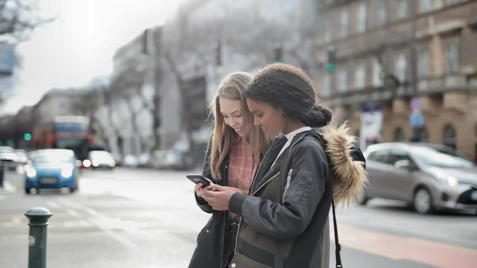 People using an app to rent cars at sunset in the city
