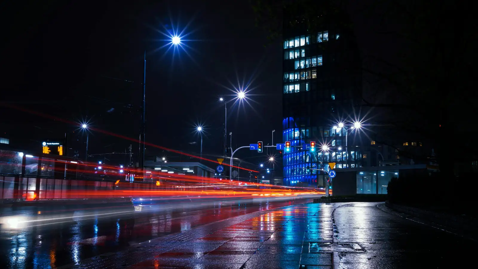 Night drive with car lights in a European city street