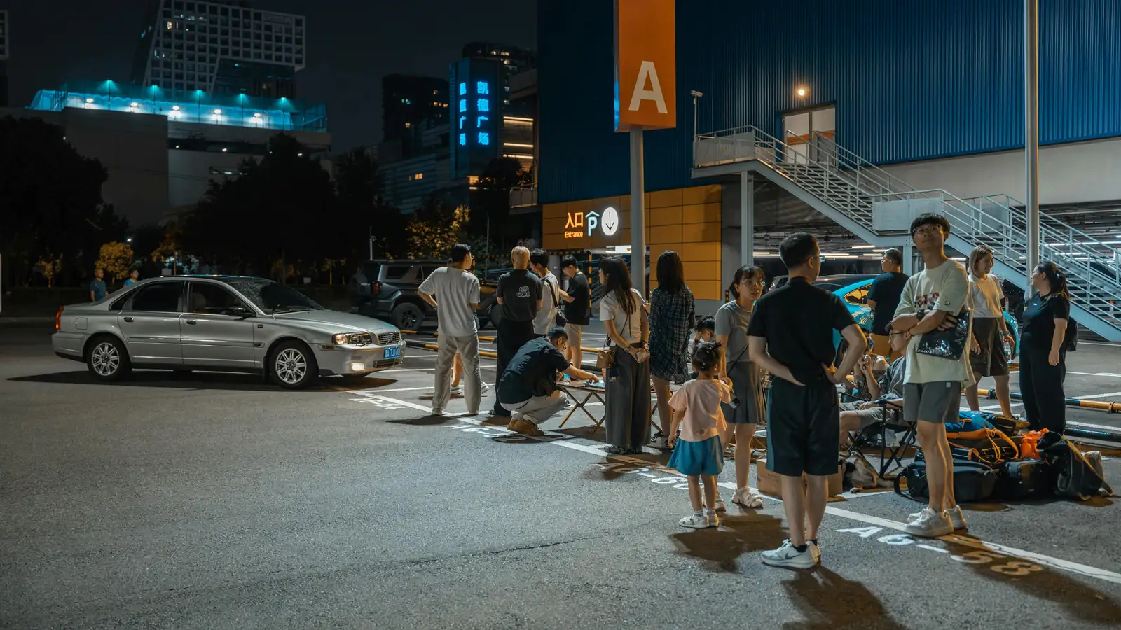 Happy customers standing by a rental car